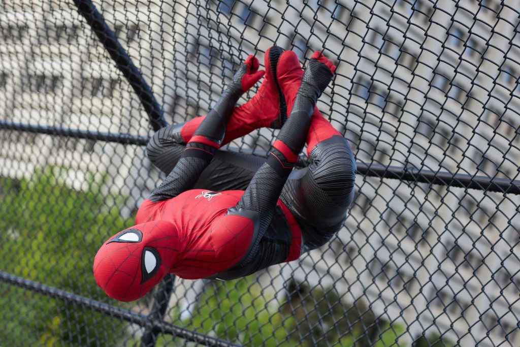 Spider man hangs upside down from a fence at tunneys pasture.