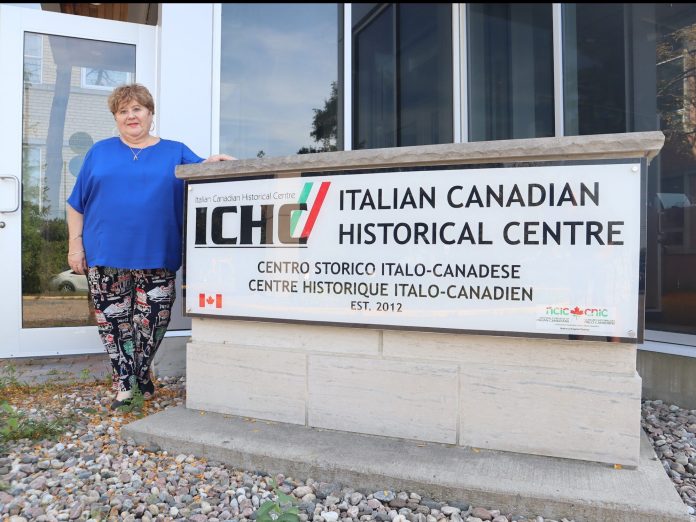 Trina stands in front of a sign for the Italian Historical Centre.