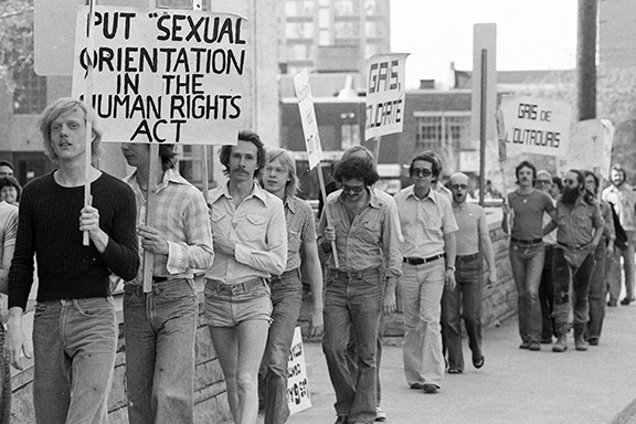 Picketers march with signs in downtown Ottawa.