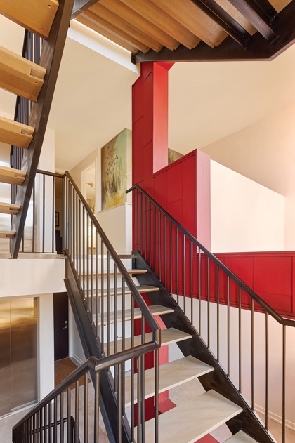 A stairwell with a red wall on the right.