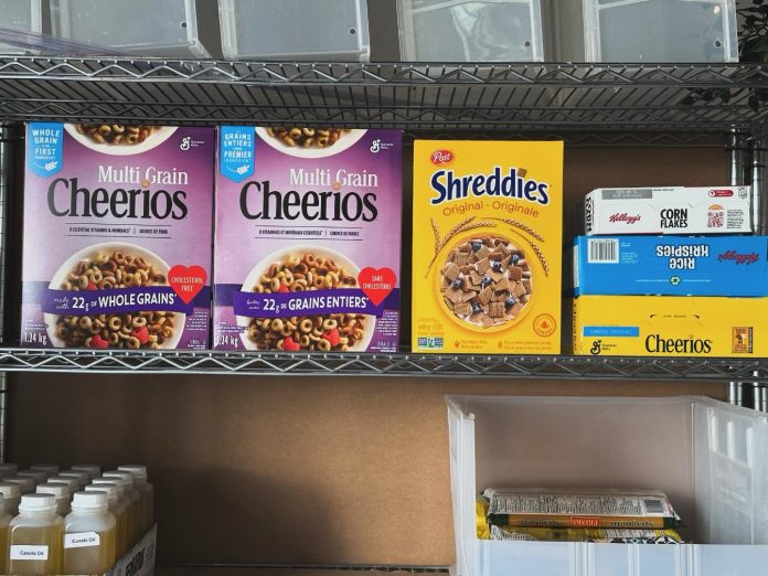 Boxes of Cheerios sit on a shelf.