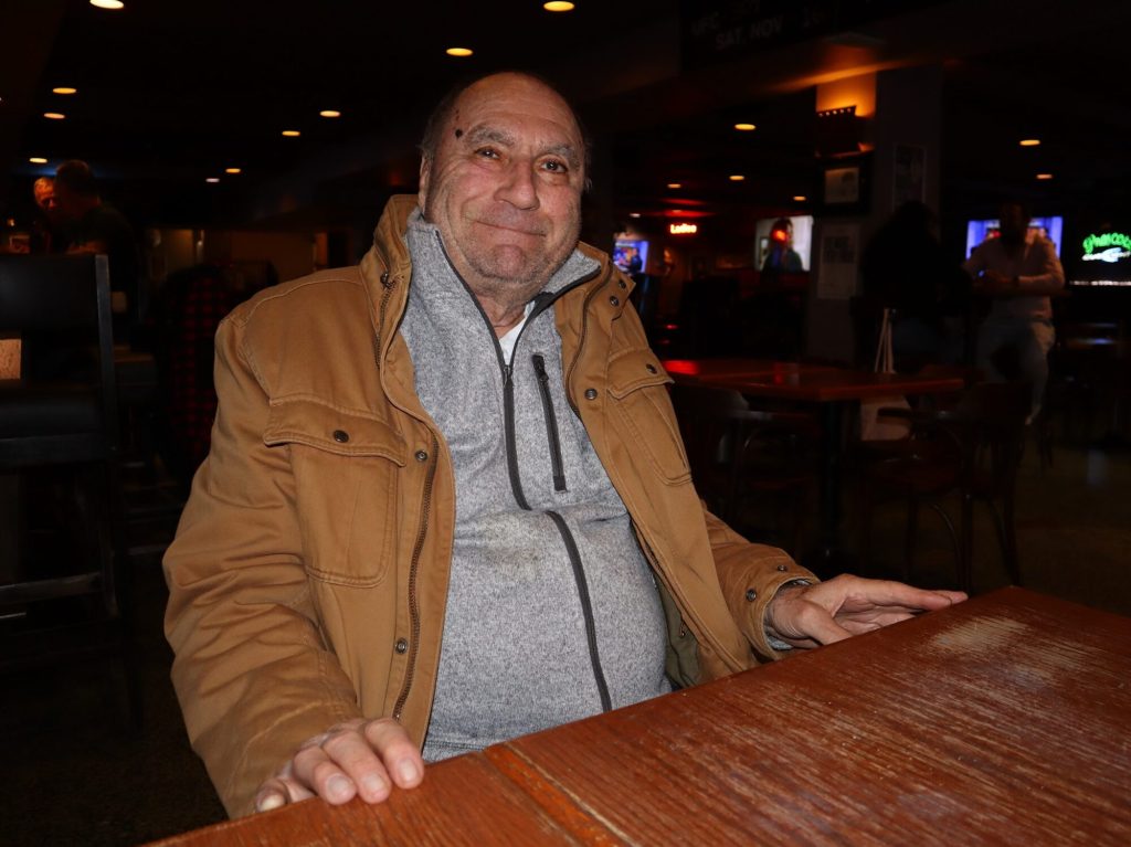 Michael sits at a table in the Prescott and poses for a photo.